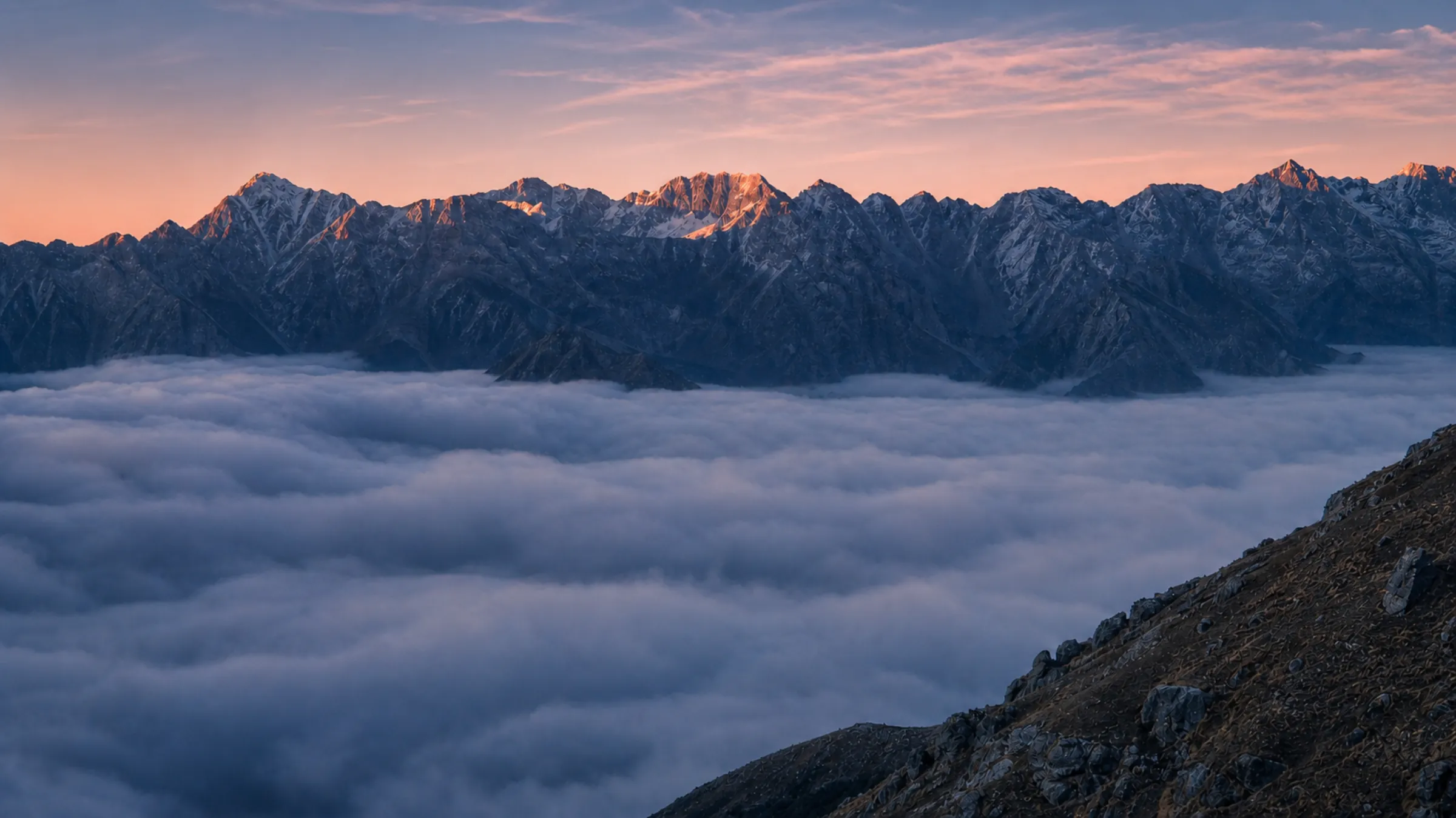 Himalayan peaks above a sea of cloud at dawn